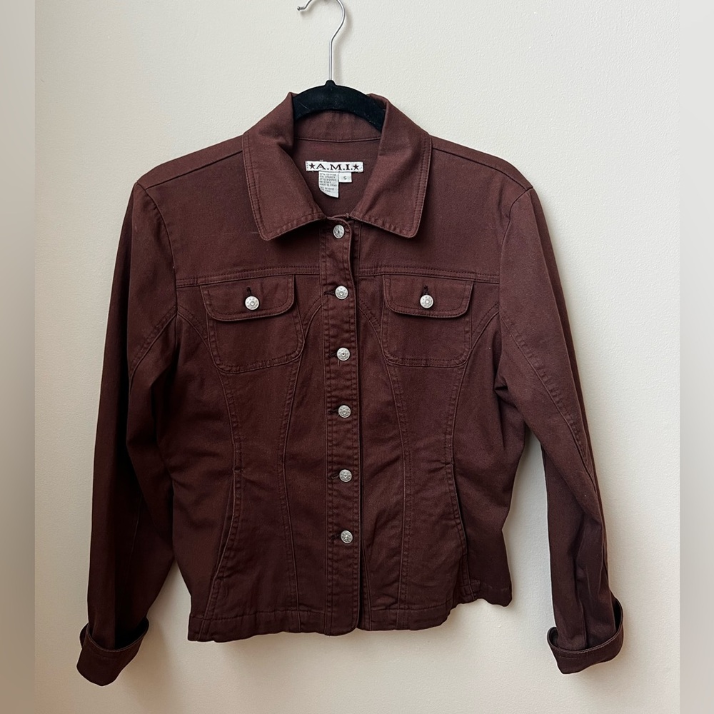 Brown jean jacket with diamond detailed buttons.